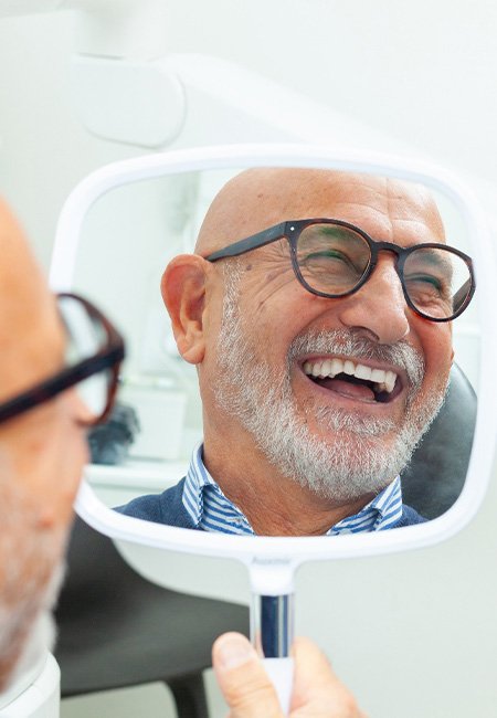 a man smiling in the mirror
