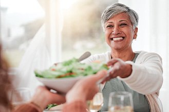 A woman sharing a bowl of salad