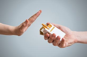 Hands pushing away cigarettes