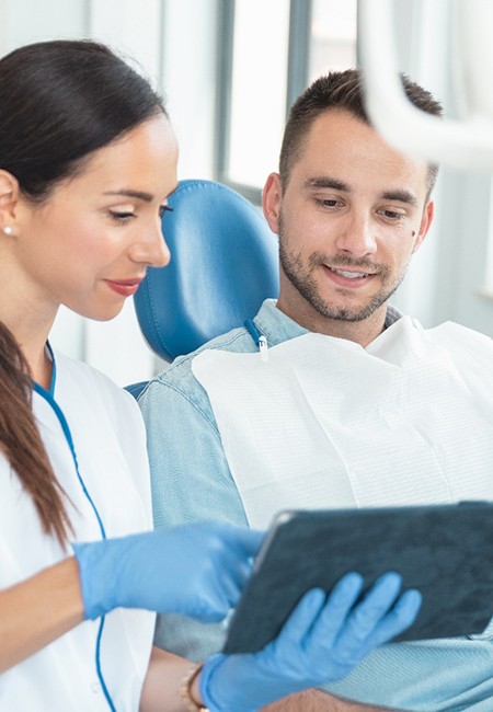 a dentist speaking with her patient