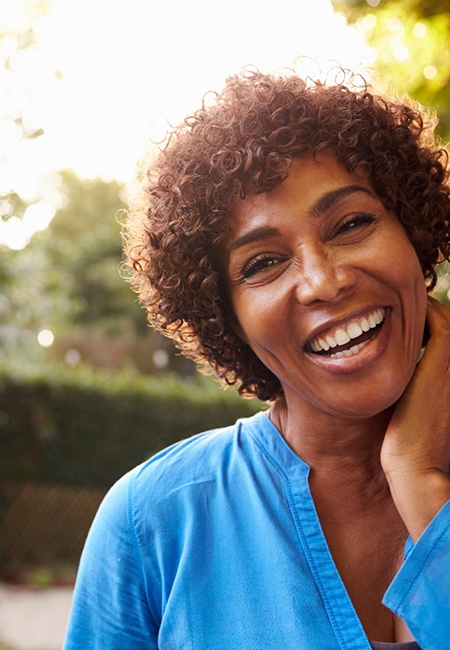 a woman smiling in a park