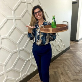 Dental team member holding tray with green bottle