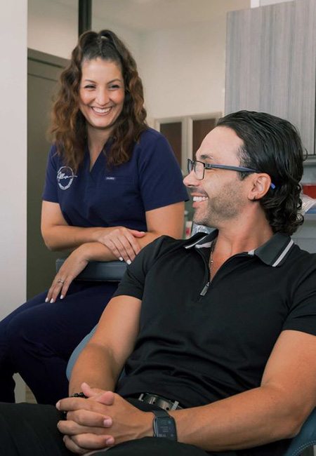 Dental team member smiling with a patient