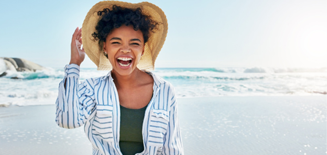 Woman showing off teeth whitening results in Lutz 