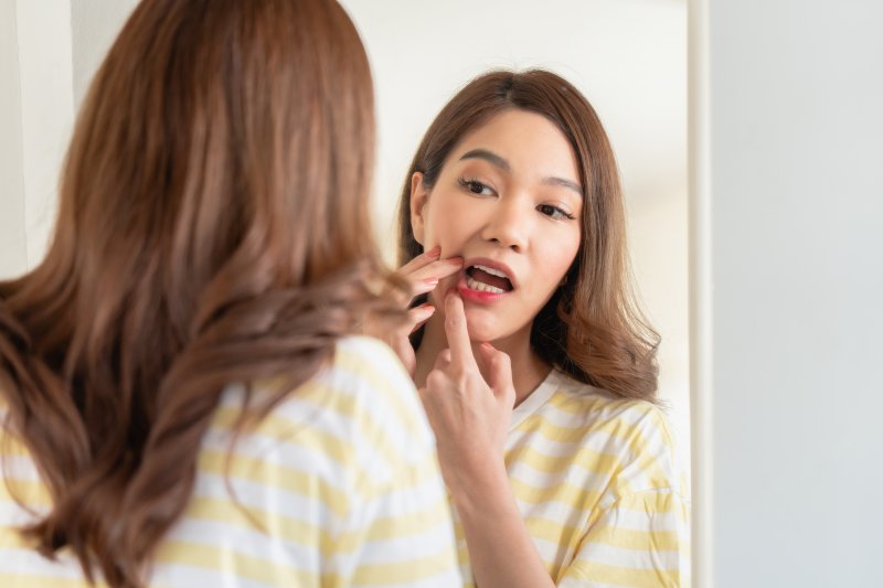 Patient looking in mirror after veneer fell off